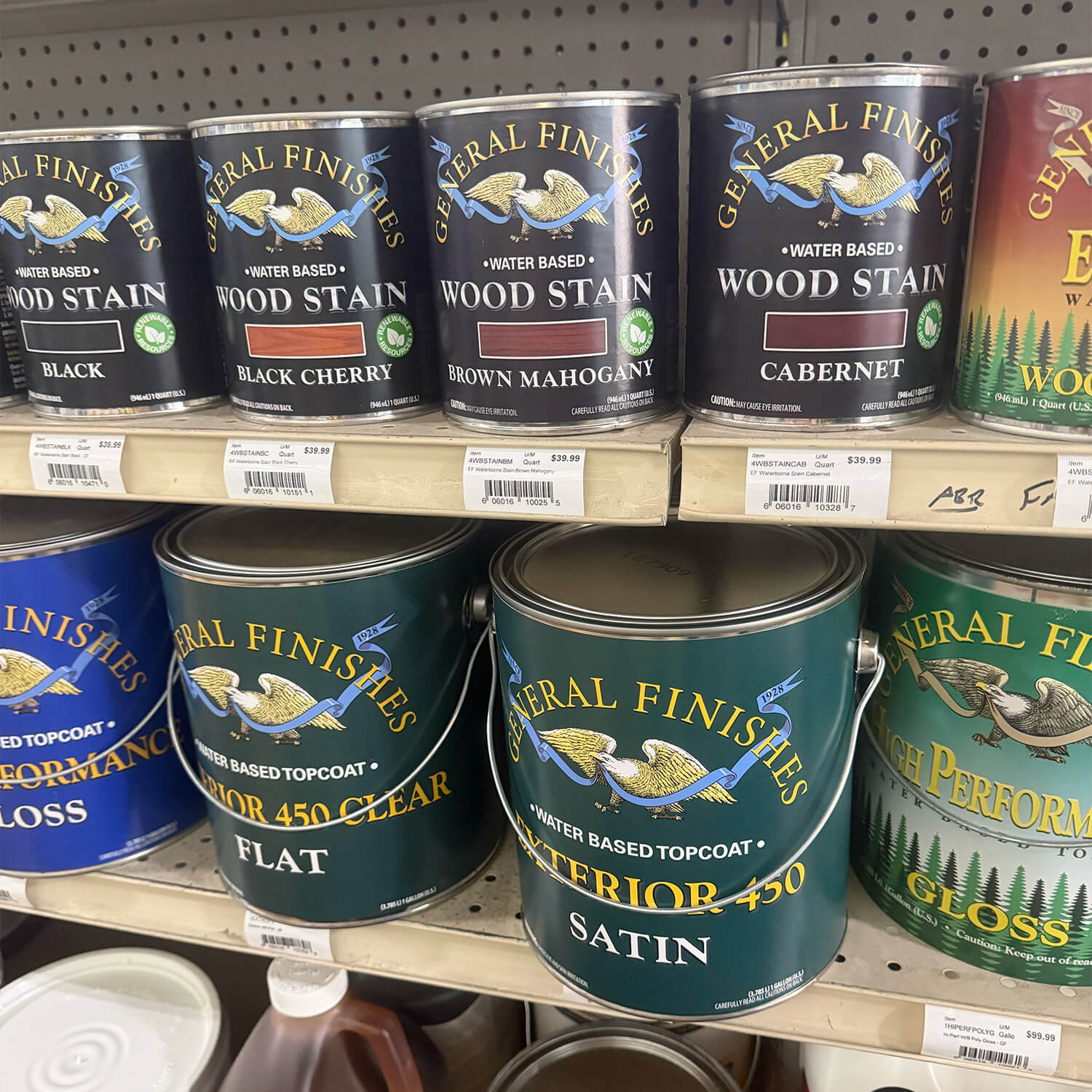 General Finishes wood stain quarts and Exterior 450 topcoat gallons with pressure-sensitive labels on a store shelf