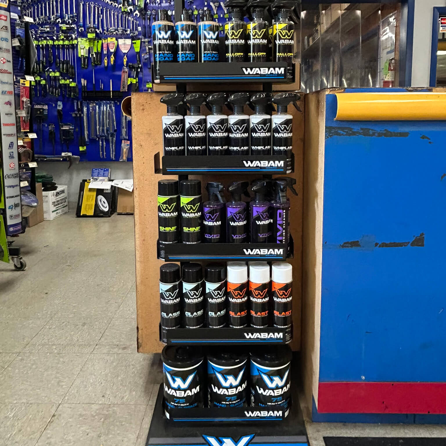 WABAM detailing sprays, aerosols, and wipes canisters with pressure-sensitive labels on a store display rack
