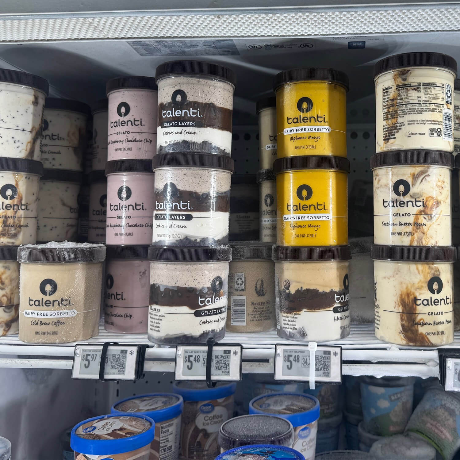 Talenti gelato and sorbetto jars with screen-printed graphics stacked in a grocery freezer