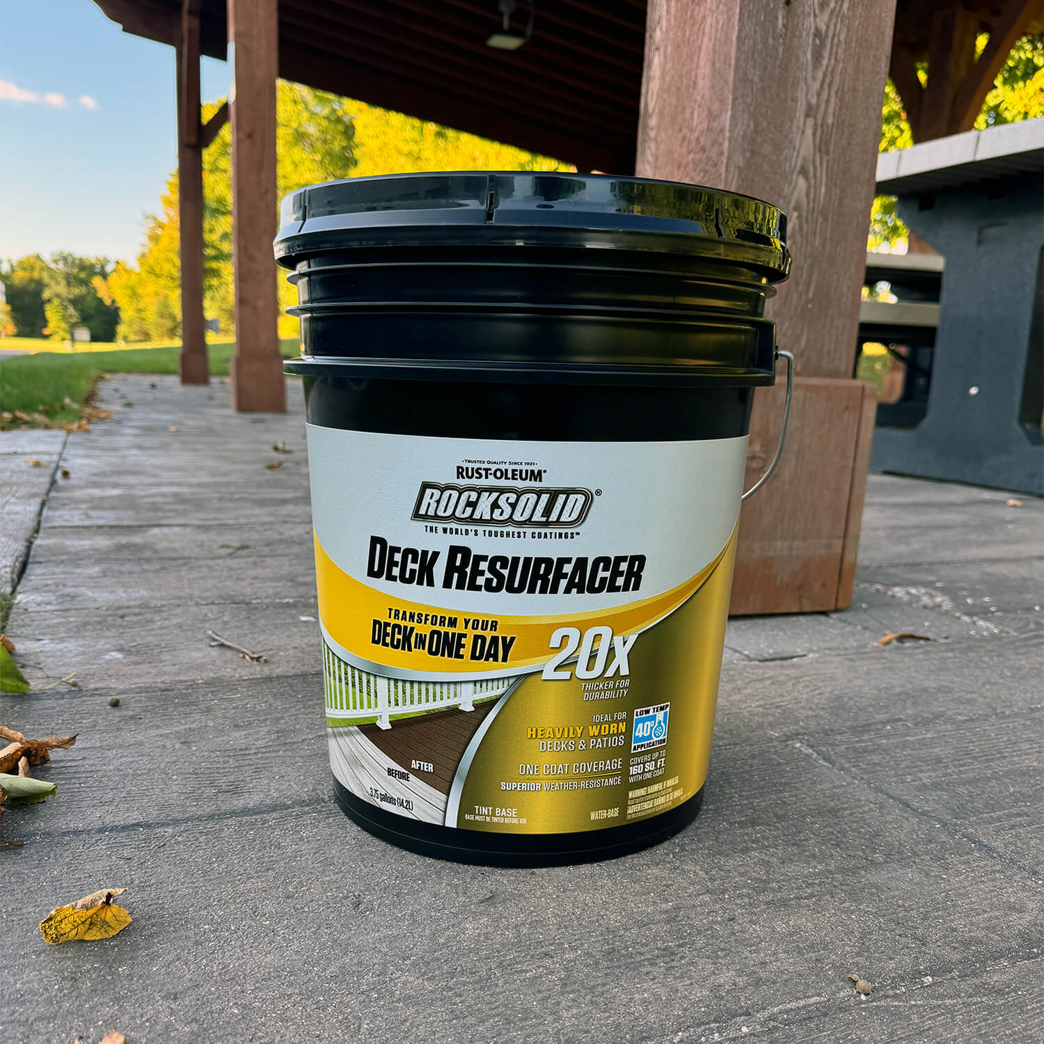 A Rust-Oleum RockSolid Deck Resurfacer pail with a full-wrap label on a concrete patio